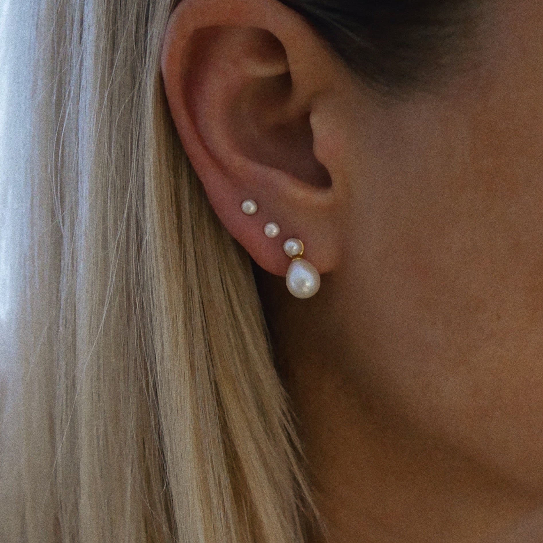 Birsenaite pearl drop stud earrings on model