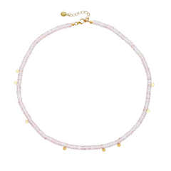 A choker necklace with rose quartz beads and gold-tone discs, displayed against a white background