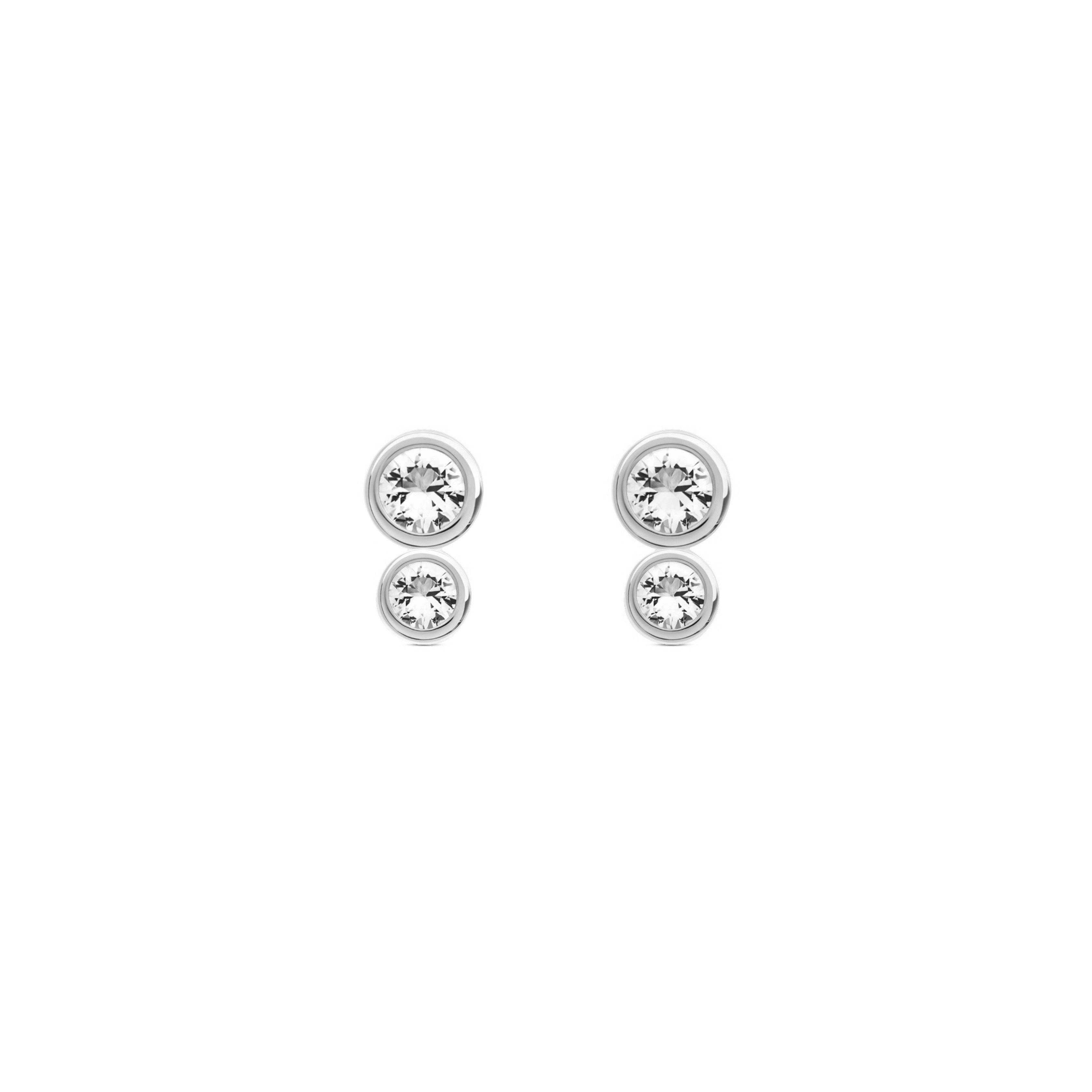 Set of four silver stud earrings with clear gemstones on a white background