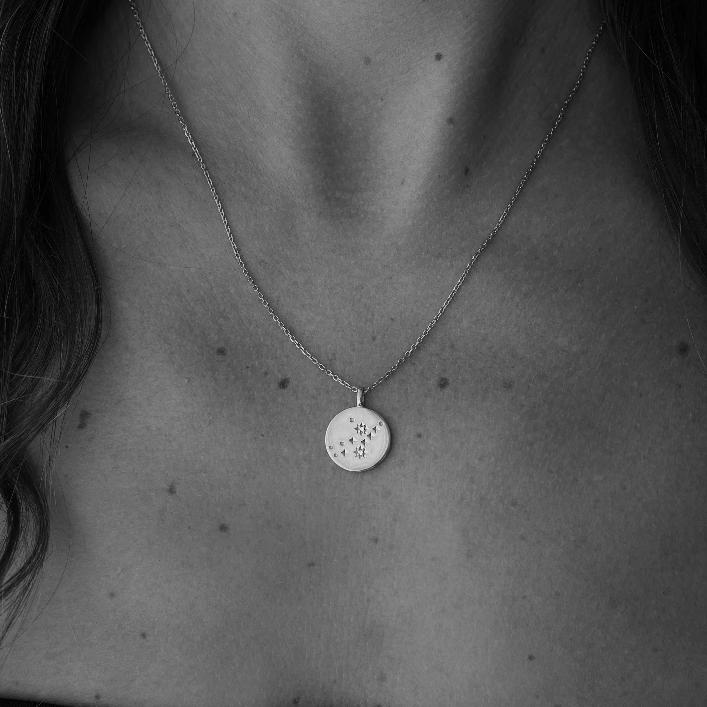 Close-up of a necklace with a pendant on a dark background